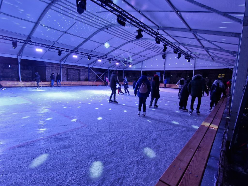 Blue event lighting at the seasonal ice rink in Lukiskes Prison 2.0 courtyard
