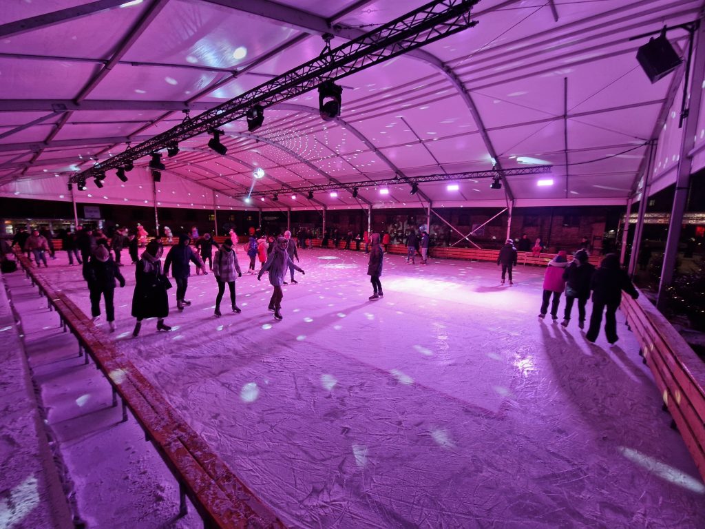 Visitors at the seasonal ice rink in Lukiskes Prison 2.0 courtyard